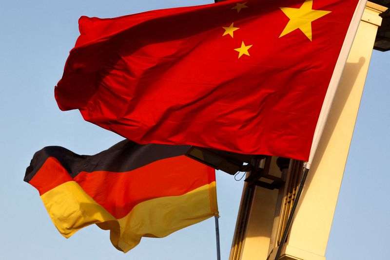 FILE PHOTO: German and Chinese national flags fly in Tiananmen