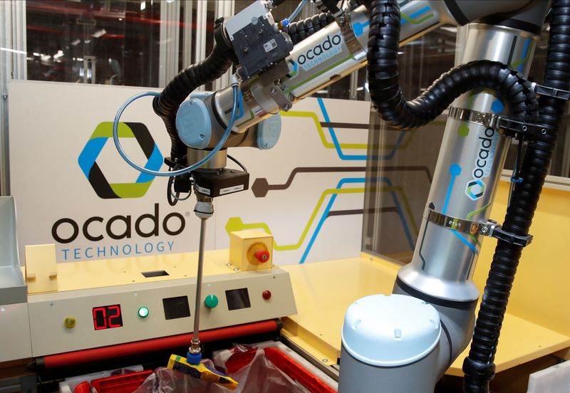 Ocado robots are seen inside a warehouse in Erith