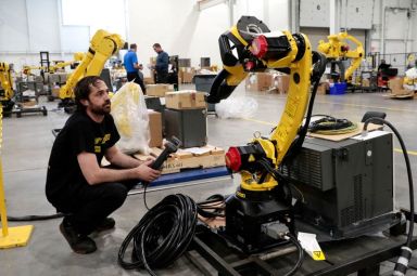 FILE PHOTO: An inventory of manufacturing robots waiting to be