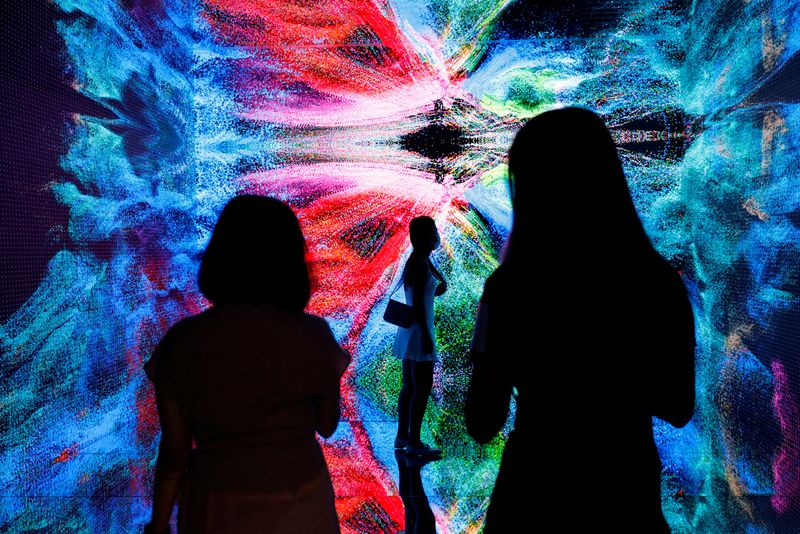 FILE PHOTO: Visitors are pictured in front of an immersive