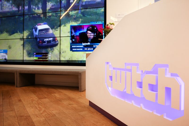 A wall of video monitors with real-time video game play
