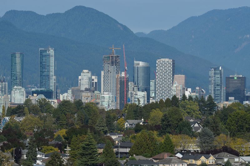 Condominium and office towers are seen on the mountain-backed skyline
