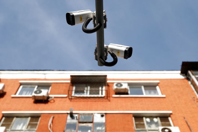 Surveillance cameras overlook a street next to a residential building