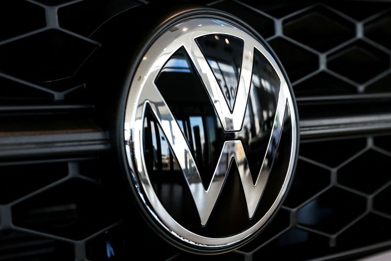 A VW badge is seen on a car at a
