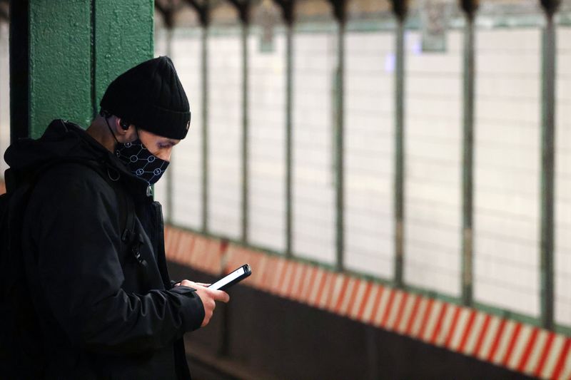 FILE PHOTO: A person uses a smartphone on a subway