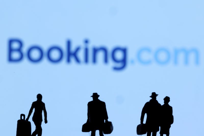 FILE PHOTO: Figurines are seen in front of Booking.com logo