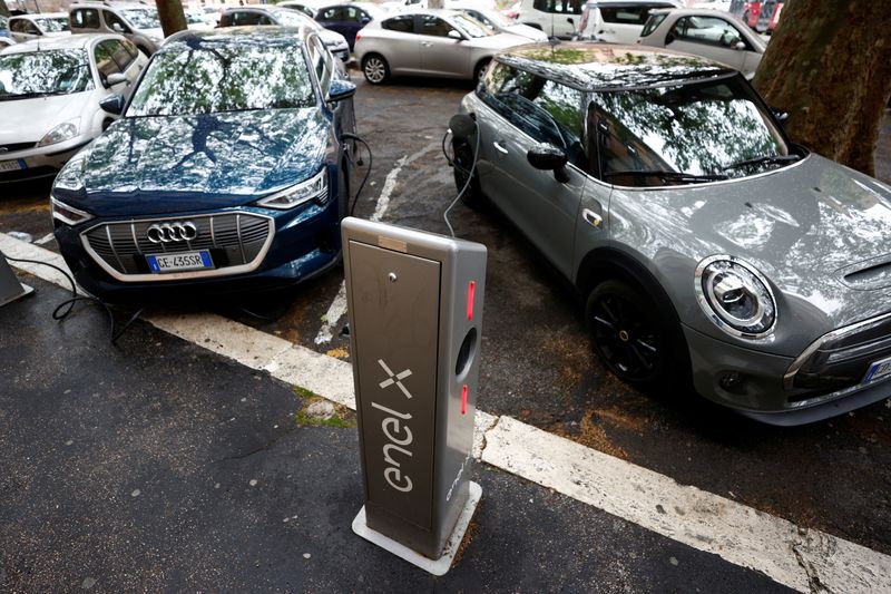 Electric cars are plugged in at a charging point for