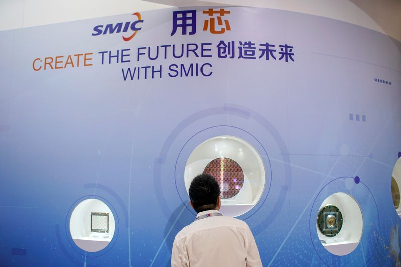 A man visits a booth of Semiconductor Manufacturing International Corporation