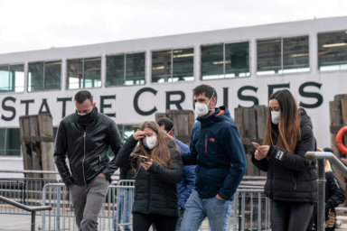 FILE PHOTO: Visitors wearing a surgical mask are seen following