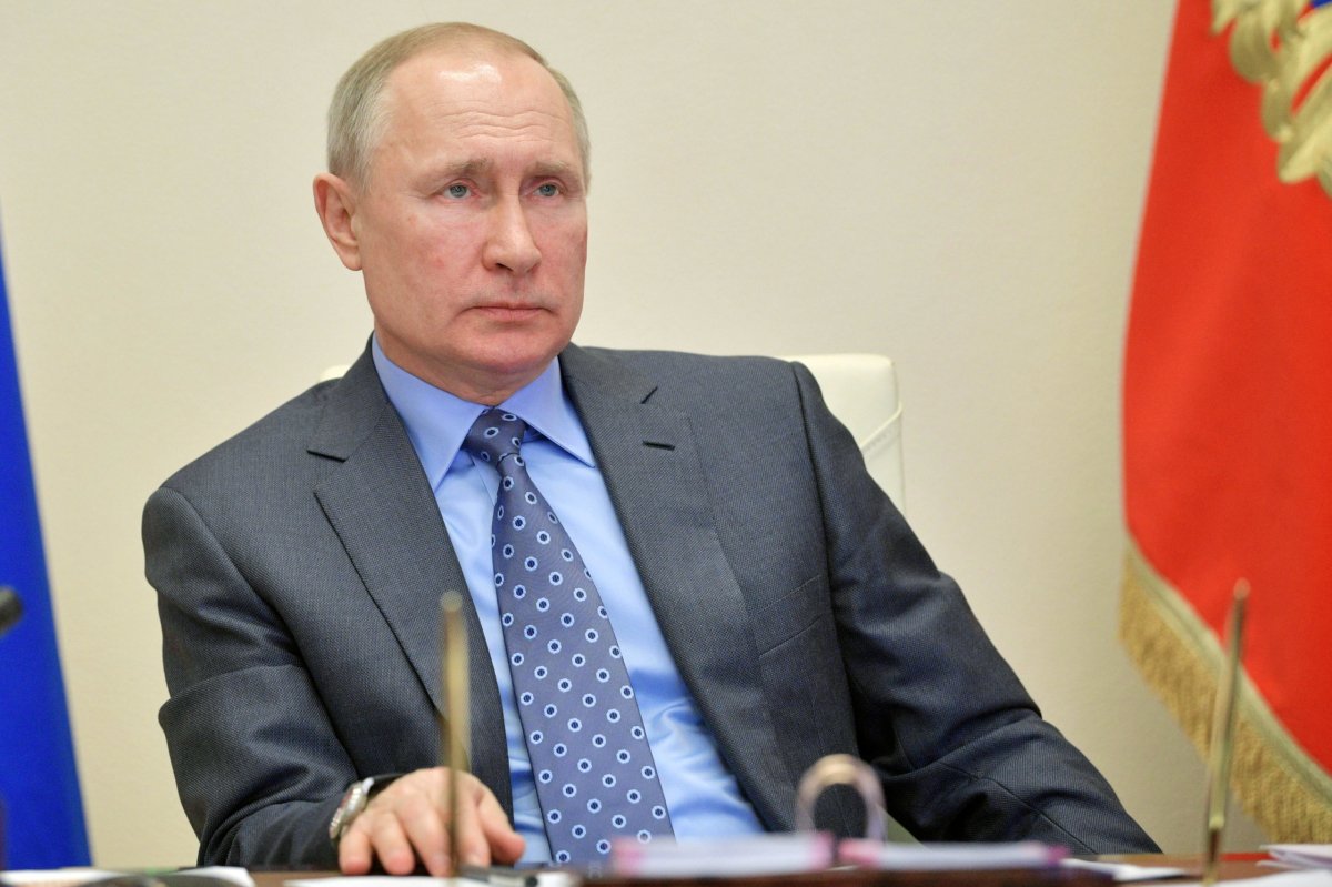 Russian President Vladimir Putin chairs a meeting with members of the