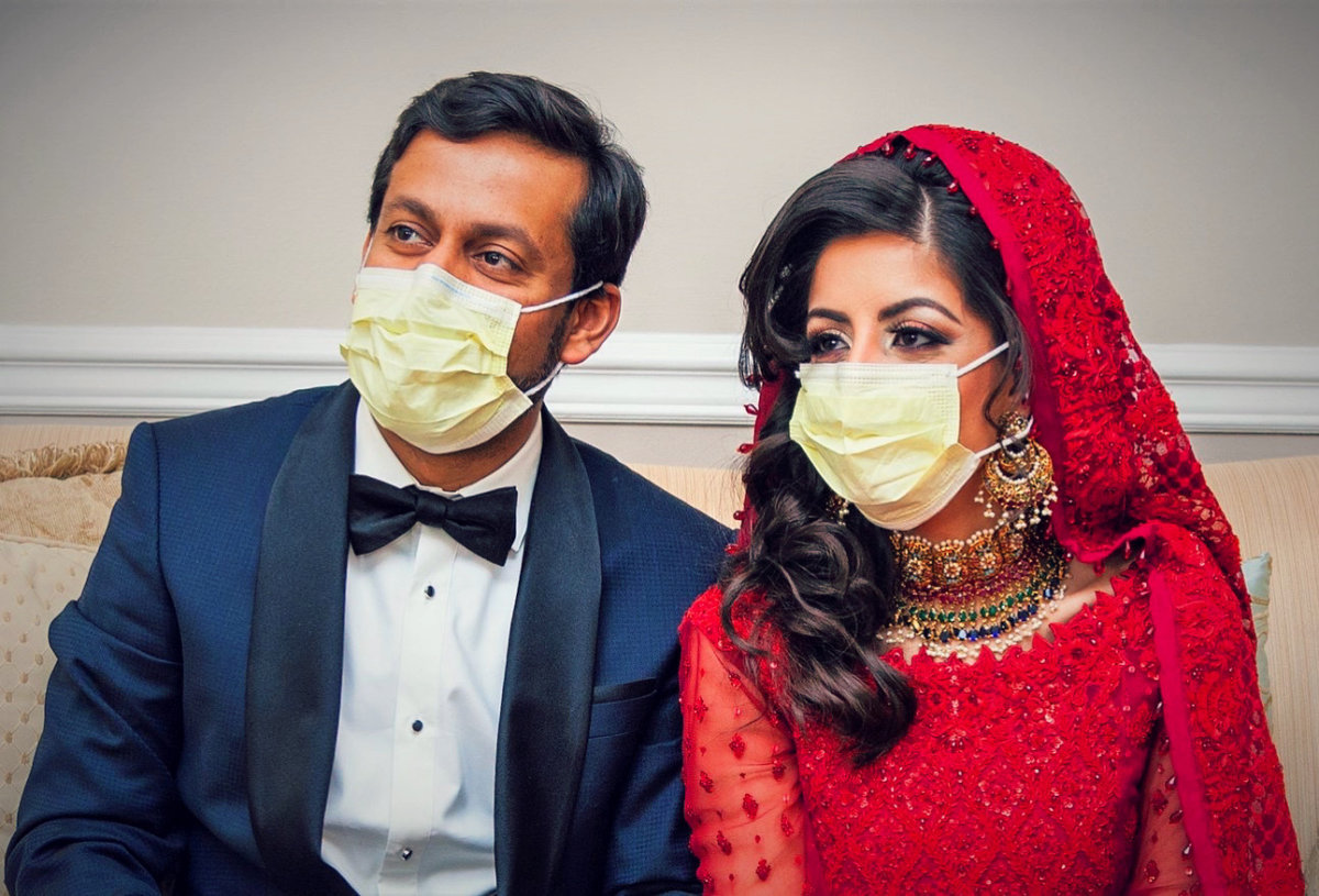 Doctors Kashif Chaudhry and Naila Shereen wear face masks after