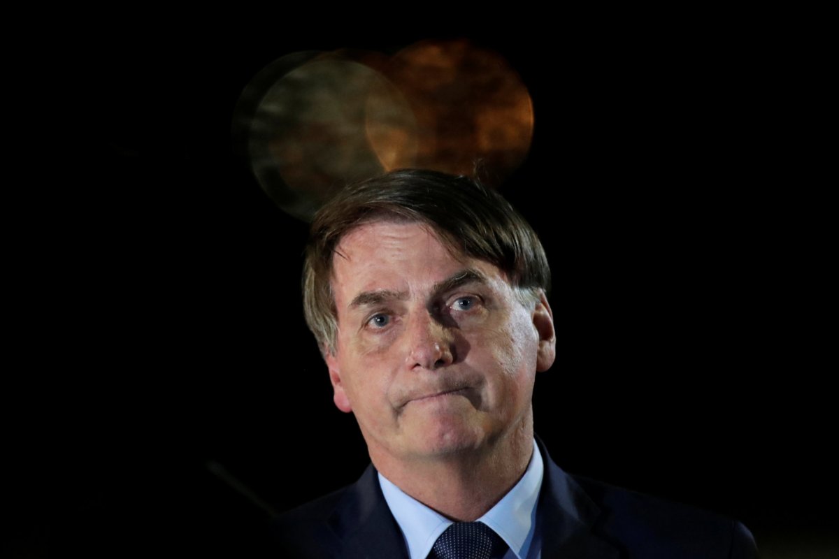 Brazil’s President Jair Bolsonaro reacts while meeting supporters as he