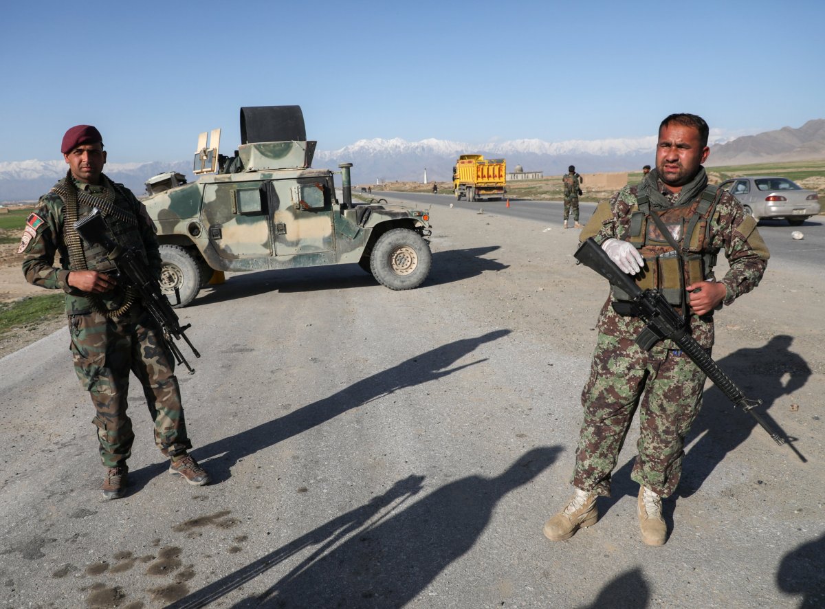 Afghan National Army (ANA) soldiers stand guard at a check