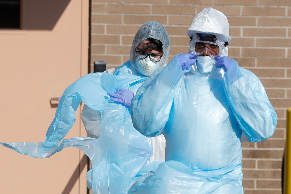 Healthcare workers in PPE outside Wyckoff Heights Medical Center during
