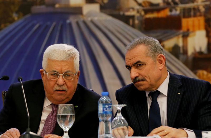 FILE PHOTO: Palestinian President Abbas looks on as Palestinian PM