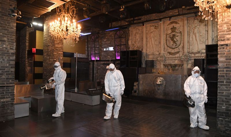 Quarantine worker spray disinfectants at a night club on the
