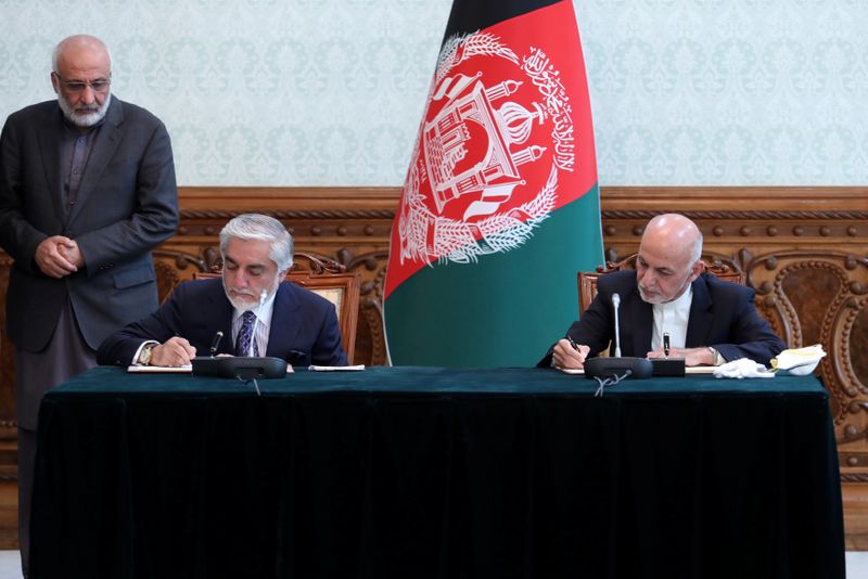 Afghanistan’s President Ashraf Ghani and his rival Abdullah Abdullah sign