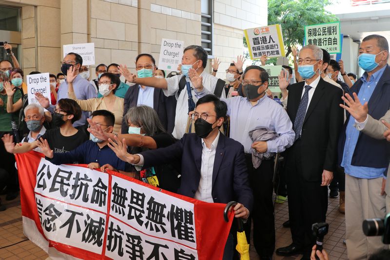 Pro-democracy activists chant slogans outside the West Kowloon Magistrates Court,