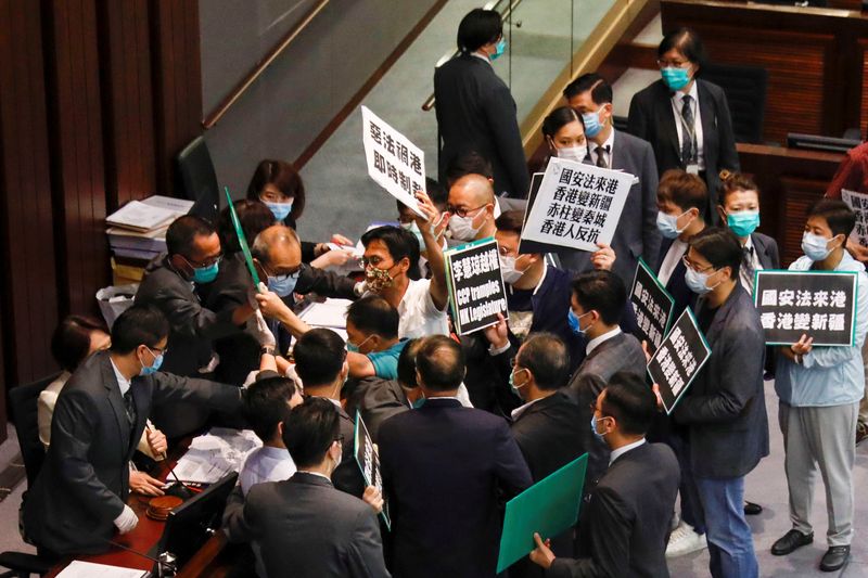 Pan-democratic legislators scuffle with security as they protest against new