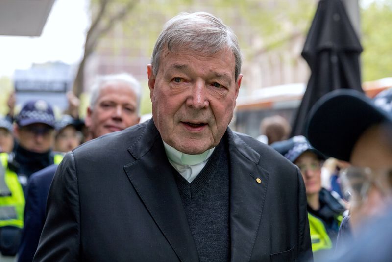 FILE PHOTO: Vatican Treasurer Cardinal George Pell is surrounded by