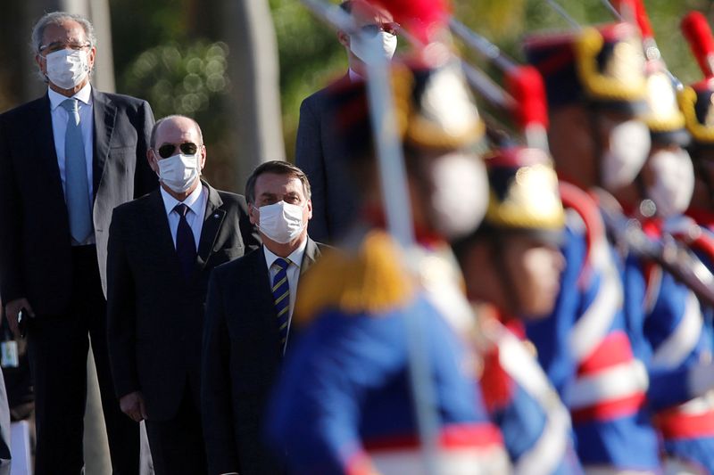 FILE PHOTO: Brazil’s President Jair Bolsonaro wearing a protective and