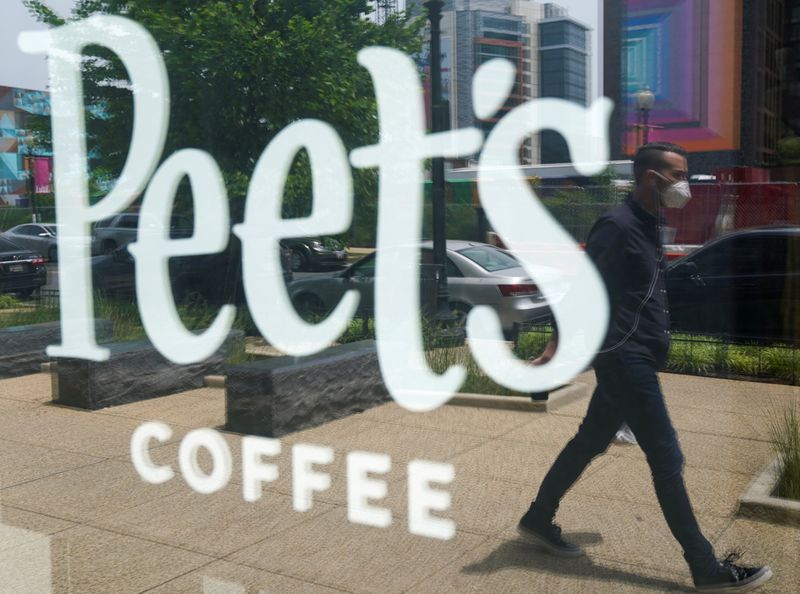 A man passes a Peet’s coffee shop in Washington, USA
