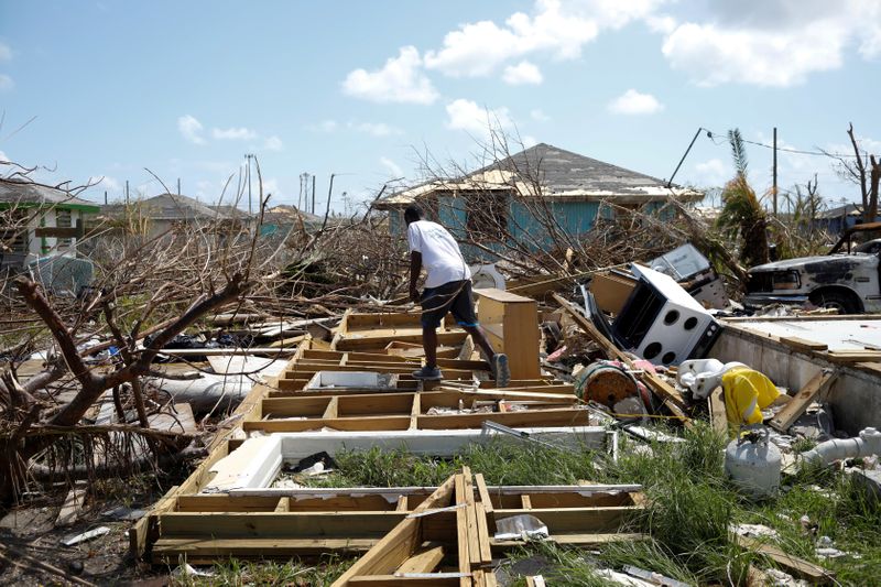 FILE PHOTO: A man walks among the debris of his
