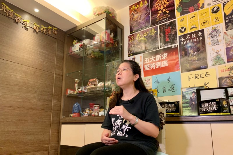 Office worker Daisy Lam speaks to Reuters at her living