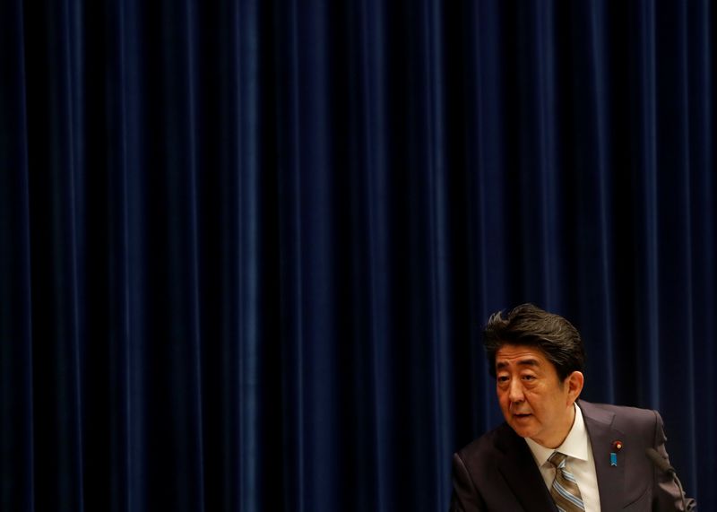 Japan’s Prime Minister Shinzo Abe listens to a question from