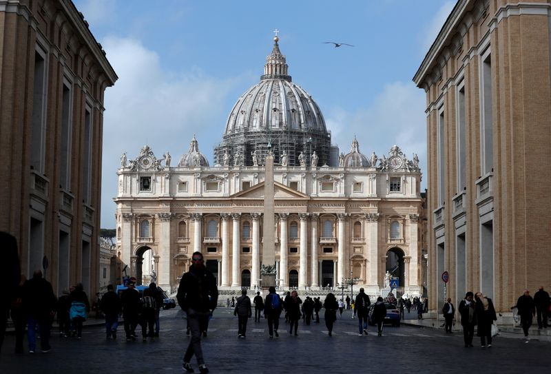 FILE PHOTO: People walk on St. Peter’s Square after the