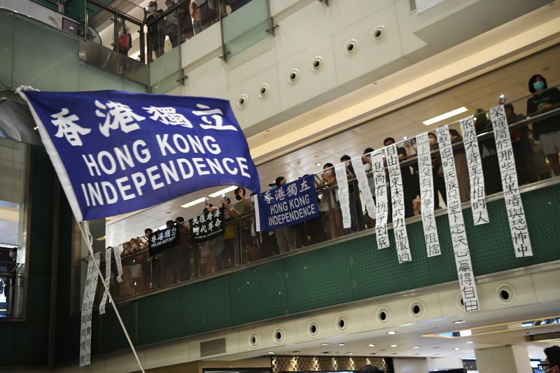 Pro-democracy protesters waves a pro-independence banner during a protest at