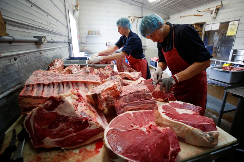 Butchers Allan and Gerald vande Bruinhorst work on a beef
