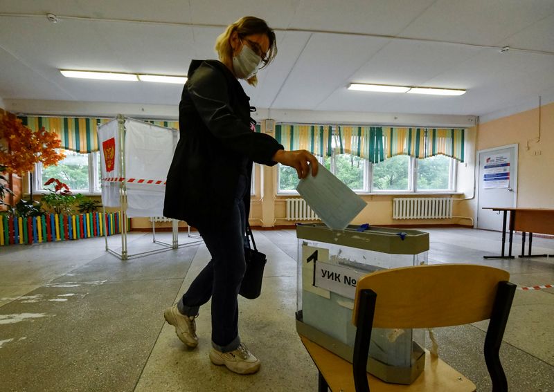 A woman casts her ballot at a polling station during