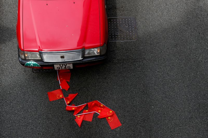 Chinese national flags are seen on the ground during a