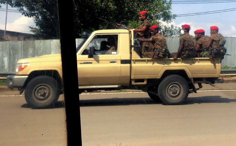 Ethiopian military ride on their pick-up truck as they patrol