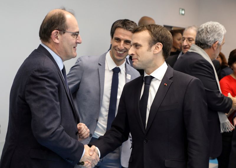 FILE PHOTO: French President Emmanuel Macron shakes hands with Interministerial