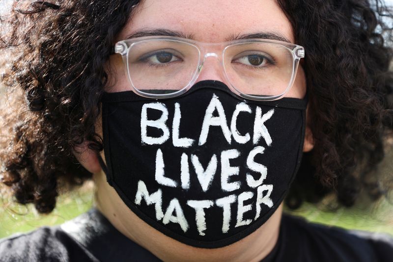 People demonstrate in solidarity with the Black Lives Matter (BLM)
