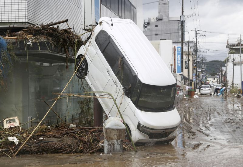 A car is pictured after it was drifted by torrential