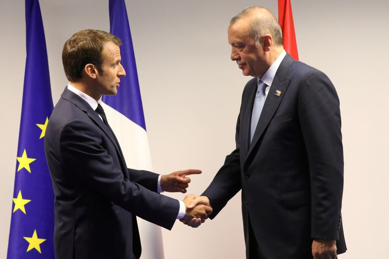FILE PHOTO: France’s President Emmanuel Macron shakes hands with Turkey’s
