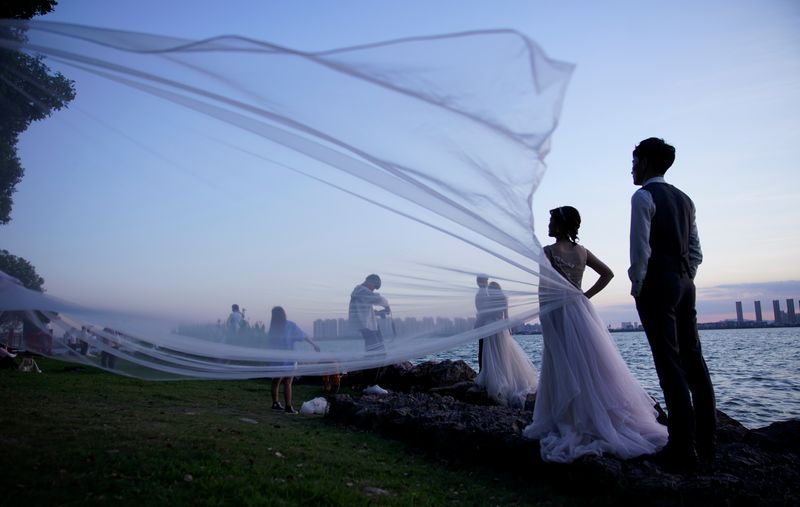 The Wider Image: Coronavirus dampens celebrations in China’s wedding gown