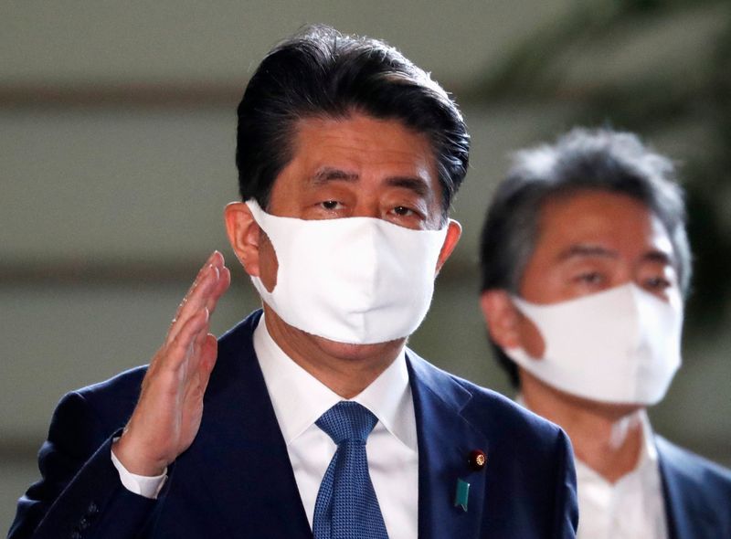 Japan’s Prime Minister Shinzo Abe wearing a protective face mask