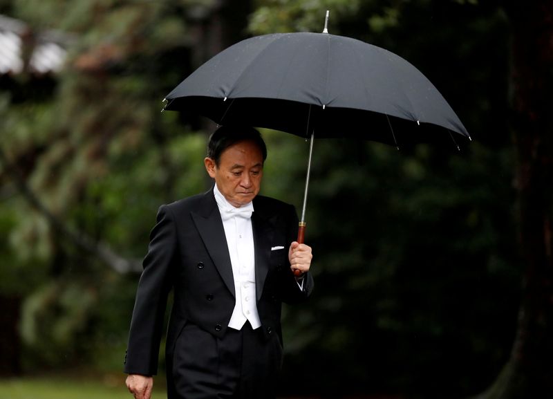 FILE PHOTO: Japan’s Chief Cabinet Secretary Yoshihide Suga arrives at