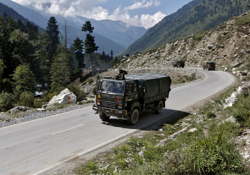 Indian army trucks move along a highway leading to Ladakh,