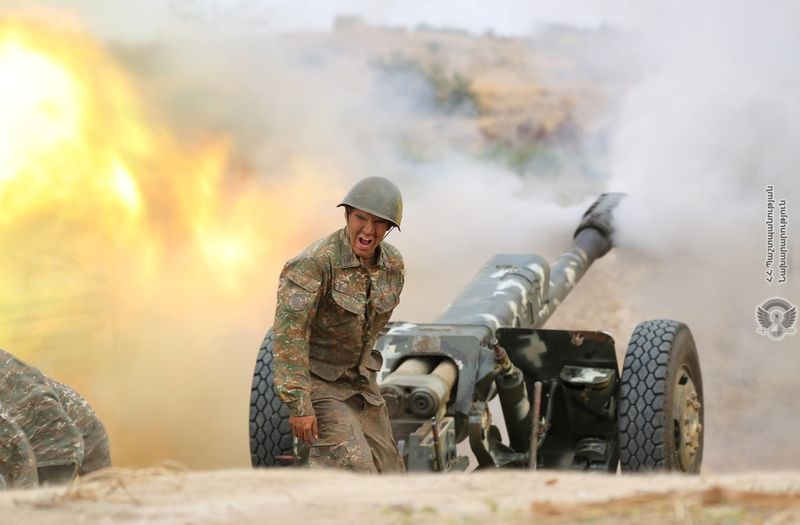An ethnic Armenian soldier fires an artillery piece during fighting