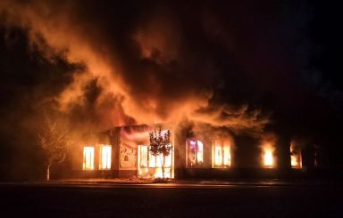 A shop is seen on fire following recent shelling during