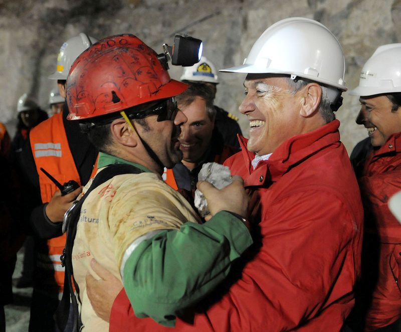 FILE PHOTO: Chilean miner Mario Sepulveda embraces President Sebastian Pinera
