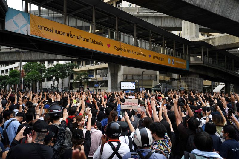 FILE PHOTO: Pro-democracy protesters show the three-finger salute as they