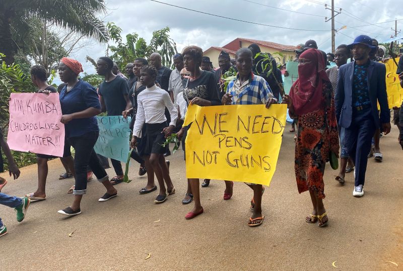 Schoolchildren, their parents and teachers hold a protest after gunmen