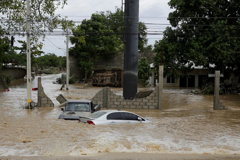 Submerged cars are pictured at an area affected by floods