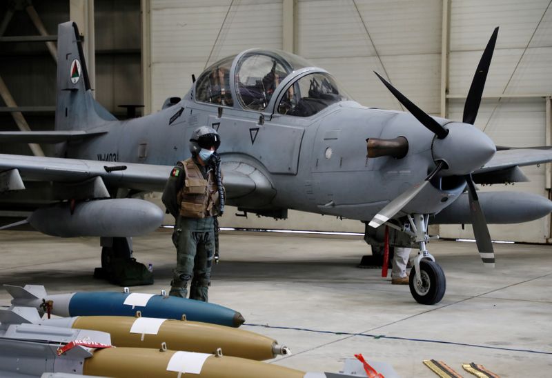 FILE PHOTO: An Afghan pilot stands next to A-29 Super